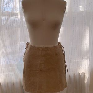 Tan Genuine Leather/suede high-wasted mini skirt with lace up side detail.